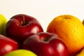 Red green apples with ripe bananas and kiwi orange lemon on a white background Royalty Free Stock Photo