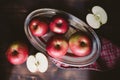 Red apples on plank wooden table