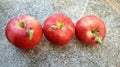 Red apples, ripe on a concrete background