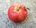 Red apples, ripe on a concrete background