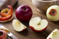 Red apples slices on wooden rustic table