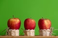 Red apples in three small baskets and green background Royalty Free Stock Photo