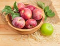 Red apples in vintage wooden fruit bowl and green apple Royalty Free Stock Photo