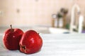 Red apples with water drops on a white table in the kitchen Royalty Free Stock Photo