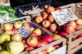 Red apples in wooden crates for sale by weight in an open market