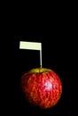 Red apples and yollow label put on black background Royalty Free Stock Photo
