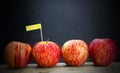Red apples and yollow label put on wooden with black background Royalty Free Stock Photo
