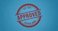 A red approved stamp on a blue background with official mark and established date Royalty Free Stock Photo