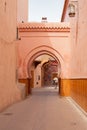 Red arch in a narrow street in Medina district in Marrakesh