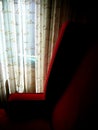 Red armchair with elaborate curtains behind Royalty Free Stock Photo