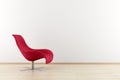 Red armchair in front of wall Royalty Free Stock Photo