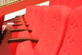 red armchairs. Empty concert hall, theater chairs background ... color photo, empty cinema or concert hall. The red
