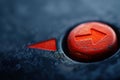 Red arrow button showing the way forward on dark background Royalty Free Stock Photo