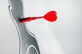 Red arrow at dart board in profile shape on grey background Royalty Free Stock Photo