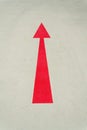 Red arrow direction sign on gray concrete road Royalty Free Stock Photo