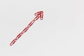 A red arrow made from paperclips pointing upwards on white background, shot from above, closeup Royalty Free Stock Photo