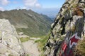 Red arrow pointing trail direction in the mountains Royalty Free Stock Photo