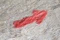 Red arrow on a stone close-up, direction forward upward ascending Royalty Free Stock Photo