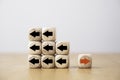 Red arrow on wooden move on different direction with black arrow on cube for business and technology disruption or unique concept Royalty Free Stock Photo