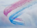 Red arrows air display with white smoke contrails Royalty Free Stock Photo