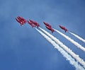 Red arrows and contrails Royalty Free Stock Photo