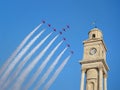 Red arrows fly over clock tower Royalty Free Stock Photo