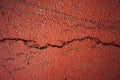 A crack in the red asphalt Royalty Free Stock Photo