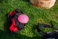 Red athletic equipment bag on the grass with pink track and field discus