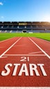 Red athletic track with START text in an empty sports stadium symbolizing new beginnings challenges and ambition Royalty Free Stock Photo