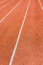 A red athletics track with white lines delimiting the lanes Royalty Free Stock Photo