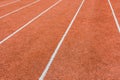 A red athletics track with white lines delimiting the lanes Royalty Free Stock Photo