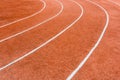 A red athletics track with white lines delimiting the lanes Royalty Free Stock Photo