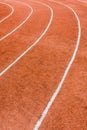 A red athletics track with white lines delimiting the lanes Royalty Free Stock Photo