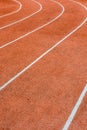 A red athletics track with white lines delimiting the lanes Royalty Free Stock Photo