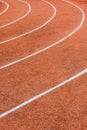 A red athletics track with white lines delimiting the lanes Royalty Free Stock Photo