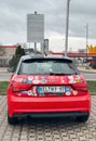 Red Audi Car with Multinational Sticker