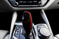 Red automatic gear stick of a modern car. Modern car interior details. Close up view. Car detailing. Automatic transmission lever Royalty Free Stock Photo