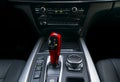 Red Automatic gear stick transmission of a modern car, multimedia and navigation control buttons. Car interior details. Royalty Free Stock Photo