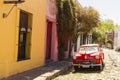 Red automobile on one of the cobblestone streets, in the city of Colonia del Sacramento, Uruguay. It is one of the oldest cities Royalty Free Stock Photo