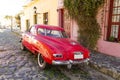 Red automobile on one of the cobblestone streets, in the city of Colonia del Sacramento, Uruguay. It is one of the oldest cities Royalty Free Stock Photo