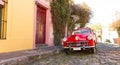 Red automobile on one of the cobblestone streets, in the city of Colonia del Sacramento, Uruguay. It is one of the oldest cities Royalty Free Stock Photo