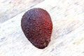 Red avocado on a background of pure ancient wood Royalty Free Stock Photo