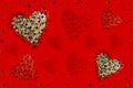 Red background with colorful hearts made of crystals stones. Frame of colored crystals. Valentine\'s Day. Christmas