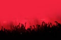 Red background with a crowd of cheering people at a concert. Royalty Free Stock Photo