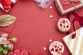 Red background with cupcakes, hearts, gifts, flowers. Copy space for valentines day greeting text