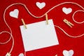 A red background from felt. A composition from heart, thread and clothespins. Background with place for write for valentines day