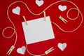 A red background from felt. A composition from heart, thread and clothespins. Background with place for write for valentines day