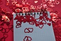 red background with hearts confetti and empty notebook Royalty Free Stock Photo