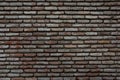 Red background of old vintage brick wall texture. Close up view of old stone brick wall with medieval masonry, Royalty Free Stock Photo