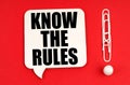 On a red background, paper clips are an exclamation mark and a thought plate with the inscription - Know the rules